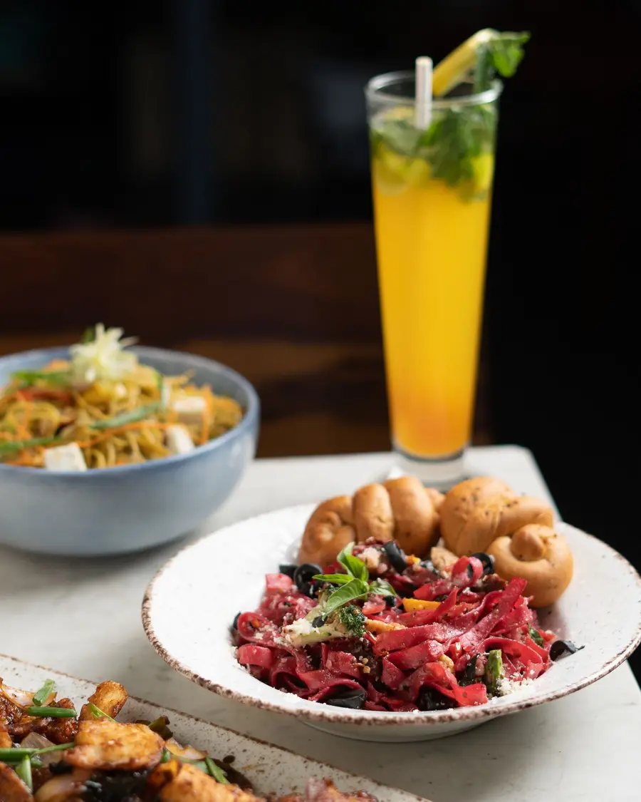 A salad and a pastry served with a fresh drink